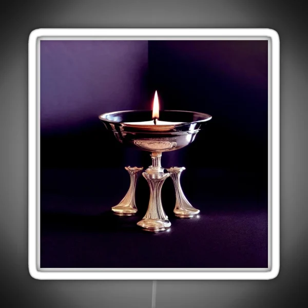 A Lit Candle In A Silver Bowl On A Table RGB Neon Sign