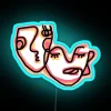Colorful abstract faces decorative neon sign with vibrant RGB lighting.