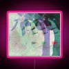 Dynamic abstract neon art featuring colorful faces amidst lush foliage.