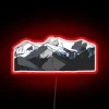 Electric Neon Sign Adorns a Snowy Mountain Landscape at Night