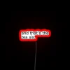 Neon sign reads sassily 'That's the tea' in bold script.