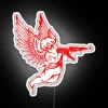 Vibrant angel icon wielding futuristic machine gun in radiant glow.