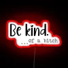 Attitude adjustment sign in bold, colorful 'be kind' defiance wording.