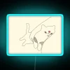Whimsical bedroom decor with vibrant RGB cat line art lighting.