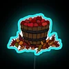 Vibrant Neon Sign Depicting Fresh Apples Amidst Autumn Foliage