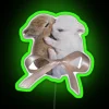 Whimsical bunnies with colorful bows in bright rainbow neon lighting.
