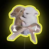 Vibrant LED sign featuring adorable bunnies in colorful rainbow hues.