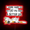 Motivational feline-themed neon sign celebrating hard work and love.