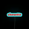 Whimsical French-inspired 'Chouette' sweet treats wall decoration with vibrant neon.
