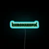 Tyler the Creator's iconic Chromakopia logo in vibrant RGB glow.