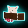Confused Feline Gamer Interrupts Role-Playing Adventure with Neon Humor Sign