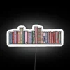 Cozy cottagecore ambiance with colorful books shelf lit by neon glow