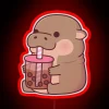 Boba-loving baby hippo's adorable drinking moment in vibrant neon