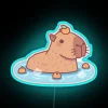 Cute capybara in hot spring with orange hat neon lighting