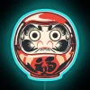 Color-changing Daruma good luck charm LED light display with vibrant glow.
