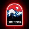 Gothic luxury travel poster featuring Dracula's iconic Transylvanian landscape in glow.