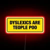 Dyslexic pride and humor displayed in bright, bold neon letters.