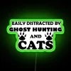 Vibrant Neon Sign Decorates Home with Whimsical Ghost and Cat Theme