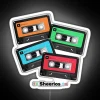 Neon music decor featuring colorful cassette tapes with Ed Sheeran album art