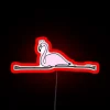 Vibrant flamingo silhouette defies gravity with gymnastic flair and color.