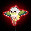 Colorful Rainbow Graphics neon sign featuring flying conure and pineapple.