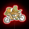 Whimsical frog and toad duo ride bike in colorful glow