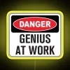 LED warning light sign with funny genius at work message.