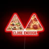 Neon sign with humorous take on imperfection in relationships nearby