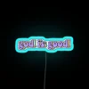 RGB neon sign featuring inspirational quote 'God Is Good' design.