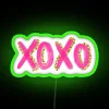 Add radiant ambiance with this golden XOXO love neon sign