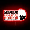 Neon horror house decor with colorful grammar-themed signage illumination.
