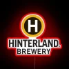 Vibrant green and blue brewery sign with glowing neon accents