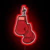 Neon-lit boxing gloves adorn a wall in vibrant, glowing color.