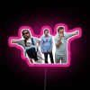 Vibrant Neon Sign Depicting a Humorous Hangover-Escape Elevator Scene