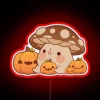 Vibrant RGB Neon Sign Depicts Cheerful Mushroom Among Orange Pumpkins.