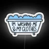 Brightly Lit Sign Featuring a Silhouette of Self-Care and Laundry