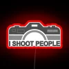Photography studio sign featuring bold, colorful 'I Shoot People' letters.