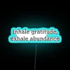 Vibrant RGB neon sign promoting mindfulness and abundant positivity always