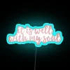 Neon inspirational quote decor featuring 'It Is Well' scripture design