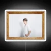Bright neon sign featuring a colorful Jimin portrait in vibrant