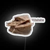 Colorful laughing iguana neon light brings playful jungle vibes indoors
