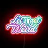 Neon 'Lets Get Weird' sign adds edgy flair to space.