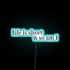 Short-lived existence neon sign with humorous mortality reminder and vibrant colors
