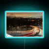 Curved Road at Dusk with Vibrant Neon Light Trails Glowing