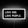 Radiant 'Love God Love People' neon sign in vibrant black RGB colors
