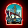 Iconic Michigan Mackinaw Bridge illuminated in vibrant RGB neon lights.