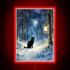 Mysterious midnight black cat silhouette in winter forest twilight glow