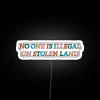 No one is illegal on stolen land statement in vibrant color