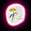 Vibrant RGB Neon Sign with Blooming Floral Design and Inspirational Quote