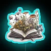 Neon Open Book Decor with Fresh Flowers and Vibrant Lights